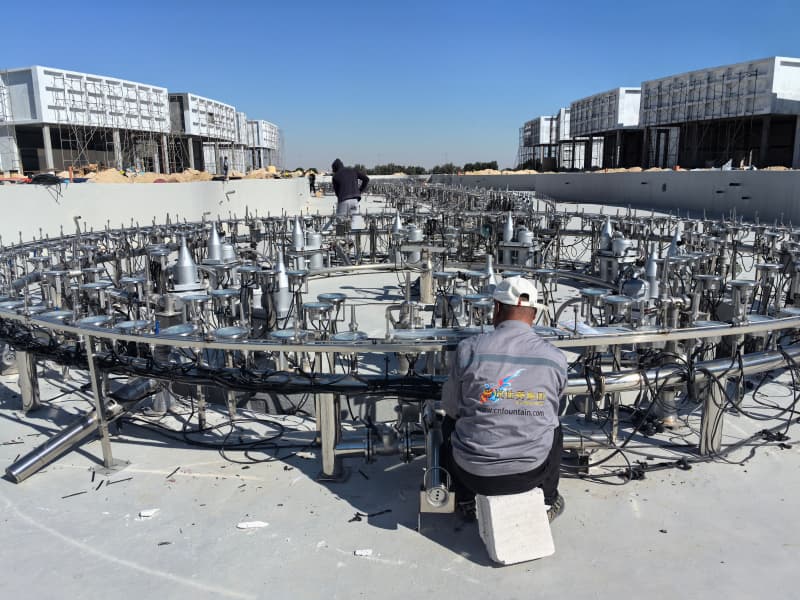 Man working on circular machinery setup.