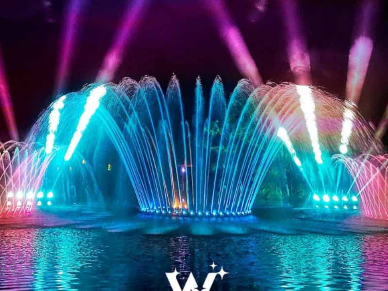 Colorful illuminated fountain display at night